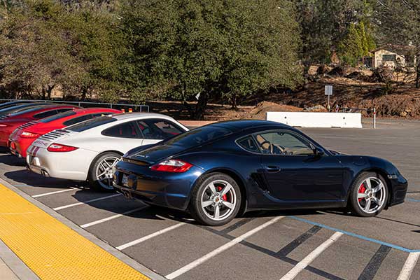 red, white and blue porsches in a line